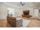 Cozy living room featuring hardwood floors, a decorative rug, and a comfortable sofa at 17566 Hyland Ln, Dade City, FL 33523