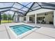 Rear exterior view showcasing a screened-in lanai with a plunge pool, perfect for relaxation at 17566 Hyland Ln, Dade City, FL 33523