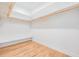 Spacious walk-in closet featuring ample shelving and a built-in bench for convenience at 17566 Hyland Ln, Dade City, FL 33523
