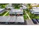 Aerial view of villa with carport, screened lanai, guest parking, and well-maintained landscaping at 1802 Bedford Ter # 185, Sun City Center, FL 33573