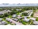 Aerial view of the villa with mature landscaping, screened lanai, carport, parking, and pleasant neighborhood at 1802 Bedford Ter # 185, Sun City Center, FL 33573
