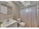 Bathroom with a white vanity sink, toilet, mirror, shower curtain and coordinated towel at 1802 Bedford Ter # 185, Sun City Center, FL 33573