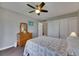 Bedroom featuring a ceiling fan, closet, and an ensuite bathroom at 1802 Bedford Ter # 185, Sun City Center, FL 33573