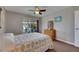 Comfortable bedroom featuring a dresser and sliding door access to the lanai at 1802 Bedford Ter # 185, Sun City Center, FL 33573