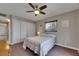 Bedroom featuring a ceiling fan, closet, and large window with natural light at 1802 Bedford Ter # 185, Sun City Center, FL 33573