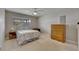 Bright bedroom featuring a bed, a window providing natural light, ceiling fan, and a wooden dresser at 1802 Bedford Ter # 185, Sun City Center, FL 33573