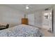 This bedroom features a cozy bed, dresser, closet, and attached bathroom with a vanity and sink at 1802 Bedford Ter # 185, Sun City Center, FL 33573