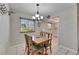 Cozy dining area featuring a window with blinds and a view into the kitchen at 1802 Bedford Ter # 185, Sun City Center, FL 33573