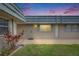 Charming home featuring a well-maintained front yard and a tranquil exterior view at dusk at 1802 Bedford Ter # 185, Sun City Center, FL 33573