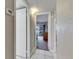 Hallway view of a bedroom featuring a slider and ceiling fan at 1802 Bedford Ter # 185, Sun City Center, FL 33573