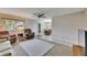 Cozy living room showcasing open concept with dining area, neutral tones, and comfortable seating at 1802 Bedford Ter # 185, Sun City Center, FL 33573