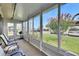 Enclosed sunroom with multiple windows offering a bright and airy space, with view of flowering tree at 1802 Bedford Ter # 185, Sun City Center, FL 33573