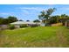 Well-maintained backyard with a lush lawn, a screened-in patio, and a storage shed at 1813 Lakeview Dr, Brandon, FL 33511
