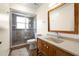Bathroom featuring a modern vanity with a white countertop and a walk-in shower with glass doors at 1813 Lakeview Dr, Brandon, FL 33511
