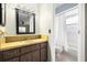 Bathroom featuring a golden vanity and a walk-in shower with white tile at 1813 Lakeview Dr, Brandon, FL 33511