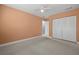 This spacious bedroom features orange walls, carpet flooring, one closet and great natural light at 1813 Lakeview Dr, Brandon, FL 33511