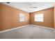 This spacious bedroom features orange walls, carpet flooring and great natural light at 1813 Lakeview Dr, Brandon, FL 33511