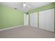 This spacious bedroom features green walls, carpet flooring, two closets and great natural light at 1813 Lakeview Dr, Brandon, FL 33511