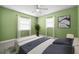 Charming bedroom with green walls, and great natural light from two windows at 1813 Lakeview Dr, Brandon, FL 33511