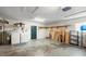 Spacious garage featuring laundry appliances, storage shelves, and ample room for various projects at 1813 Lakeview Dr, Brandon, FL 33511