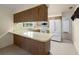 Functional kitchen with a breakfast bar, white appliances, and wood cabinetry at 1813 Lakeview Dr, Brandon, FL 33511