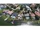 High-angle view showcasing three waterfront estates, each featuring its own pool and dock at 1967 Brightwaters Ne Blvd, St Petersburg, FL 33704