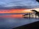 Picturesque sunrise view over the water with a silhouette of a private dock in the foreground at 1967 Brightwaters Ne Blvd, St Petersburg, FL 33704