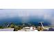Expansive waterfront view showcasing a private dock and lush tropical landscaping at 1967 Brightwaters Ne Blvd, St Petersburg, FL 33704