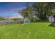 Lush green backyard with a view of the serene lake at 2016 Chelam Way, Brandon, FL 33511