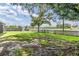 Expansive yard with fenced boundary offering a serene view of the beautiful lake at 2016 Chelam Way, Brandon, FL 33511