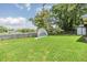 Spacious backyard features a lush green lawn, privacy fence, and serene lake views at 2016 Chelam Way, Brandon, FL 33511