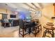 Open-concept dining area features a modern light fixture, bar stools, and seamless flow into the living area at 2016 Chelam Way, Brandon, FL 33511
