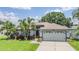 Charming single-Gathering home with a well-maintained lawn, mature trees, and two-car garage at 2016 Chelam Way, Brandon, FL 33511
