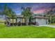 Charming single-story home with a well-manicured lawn and vibrant tropical landscaping at 2016 Chelam Way, Brandon, FL 33511