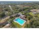 Aerial view of community pool surrounded by lush trees and residential area at 2016 Chelam Way, Brandon, FL 33511