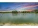Scenic view of a tranquil lake at sunset with colorful sky and lush greenery at 2016 Chelam Way, Brandon, FL 33511