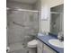 Bathroom featuring a tiled shower with a glass door and a built-in seat at 2226 Giralda Ave, Spring Hill, FL 34606