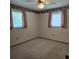 Bedroom features carpet, a ceiling fan and two windows with curtains at 2226 Giralda Ave, Spring Hill, FL 34606