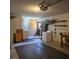 An open garage, with a washer and dryer, cabinets and shelving at 2226 Giralda Ave, Spring Hill, FL 34606