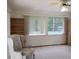 Cozy living room featuring natural light, a ceiling fan, carpet flooring and built-in bookshelves at 2226 Giralda Ave, Spring Hill, FL 34606