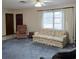 Inviting living room featuring neutral walls, plush blue carpet, and lots of natural light at 2226 Giralda Ave, Spring Hill, FL 34606