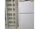 Spacious pantry beside white fridge, offering ample storage space with multiple shelves at 2226 Giralda Ave, Spring Hill, FL 34606