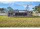 Expansive backyard featuring a well-maintained lawn and a screened-in pool area for outdoor enjoyment at 239 Freeport Ne Ave, St Petersburg, FL 33702