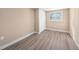 Comfortable bedroom with a neutral color scheme, hardwood floors, closet, and a bright window with shutter blinds at 239 Freeport Ne Ave, St Petersburg, FL 33702