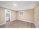 Relaxing bedroom with neutral tones, hardwood floors, a window with shutter blinds, and a bathroom right outside at 239 Freeport Ne Ave, St Petersburg, FL 33702
