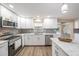 Contemporary kitchen features sleek appliances, granite counters, white cabinets, and mosaic backsplash at 239 Freeport Ne Ave, St Petersburg, FL 33702