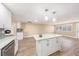 Modern kitchen featuring a central island with stone countertop, stainless steel appliances, and sleek white cabinetry at 239 Freeport Ne Ave, St Petersburg, FL 33702