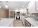 Well-equipped kitchen with stainless steel appliances, granite counters, white cabinets, and mosaic backsplash at 239 Freeport Ne Ave, St Petersburg, FL 33702