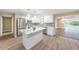 Stylish kitchen with stainless steel appliances, white cabinets, mosaic backsplash and an island with a marble countertop at 239 Freeport Ne Ave, St Petersburg, FL 33702