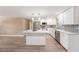 Bright kitchen with stainless steel appliances, granite counters, white cabinetry and open access to the living room at 239 Freeport Ne Ave, St Petersburg, FL 33702
